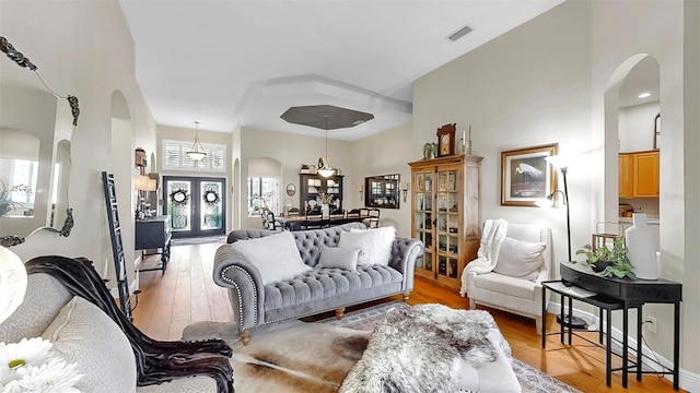 3506 Cordgrass Dr, Valrico, FL 33596 - living room featuring arched walkways, light wood-type flooring, and a high ceiling