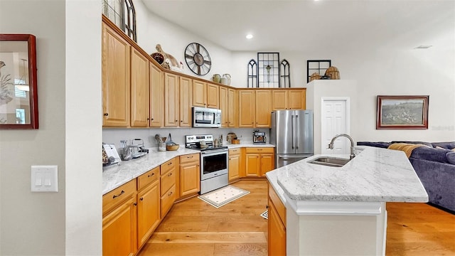 3506 Cordgrass Dr, Valrico, FL 33596 - kitchen featuring appliances with stainless steel finishes, light wood-style floors, a center island with sink, open floor plan, and recessed lighting