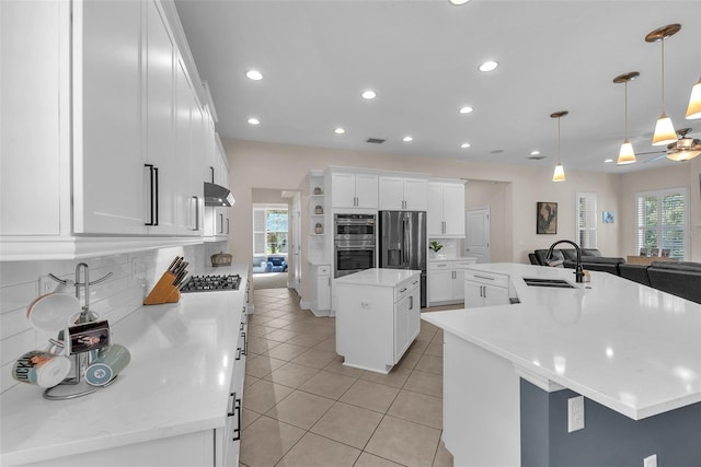 6207 Bleeker St, Riverview, FL 33578 - kitchen with a spacious island, stainless steel appliances, plenty of natural light, light tile patterned floors, and recessed lighting