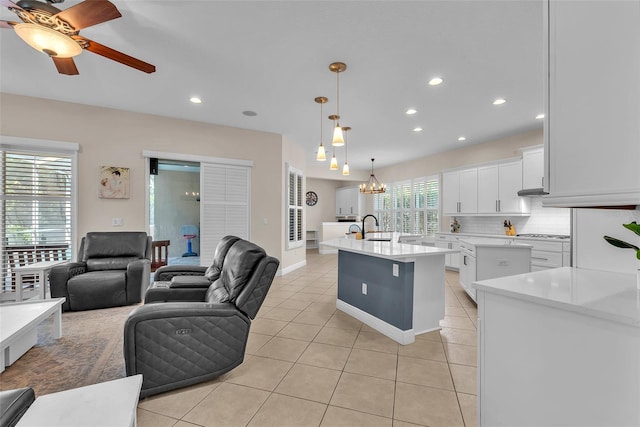 6207 Bleeker St, Riverview, FL 33578 - kitchen with open floor plan, light tile patterned floors, a center island with sink, light countertops, and recessed lighting