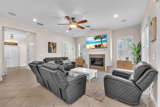 6207 Bleeker St, Riverview, FL 33578 - living room featuring a chandelier, a glass covered fireplace, light tile patterned floors, ceiling fan, and recessed lighting