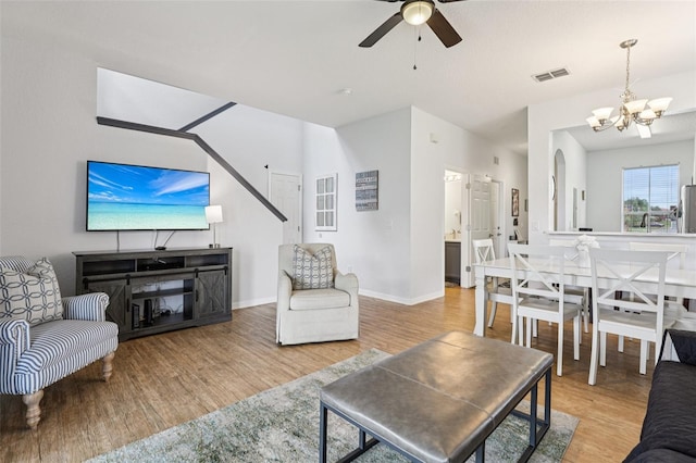 1052 Calabria Ave, Davenport, FL 33897 - living area with wood finished floors, a chandelier, and ceiling fan