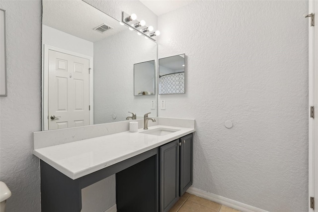 1052 Calabria Ave, Davenport, FL 33897 - bathroom with vanity, tile patterned flooring, and a textured wall