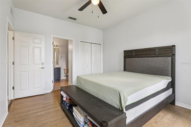 1052 Calabria Ave, Davenport, FL 33897 - bedroom featuring wood finished floors, a closet, connected bathroom, and ceiling fan
