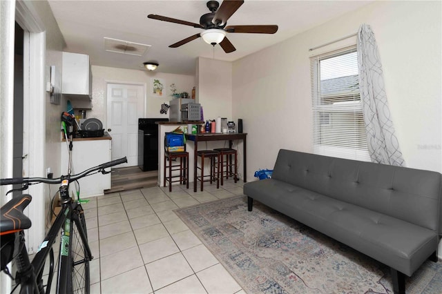 1144AND1142 7th St NW, Largo, FL 33770 - living area featuring light tile patterned floors and ceiling fan