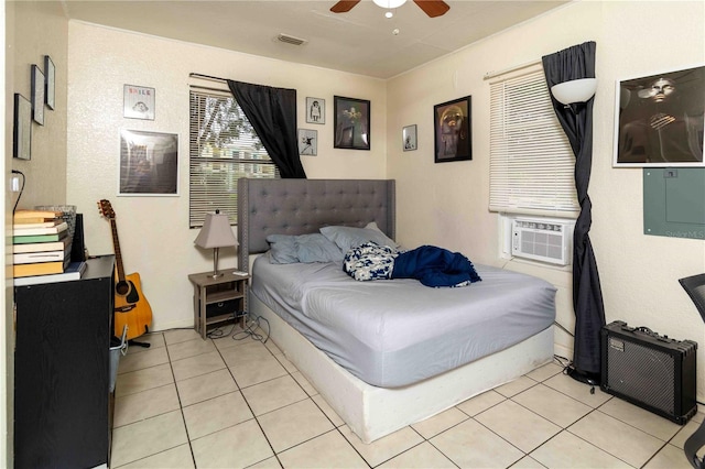 1144AND1142 7th St NW, Largo, FL 33770 - bedroom with cooling unit, light tile patterned flooring, and a ceiling fan