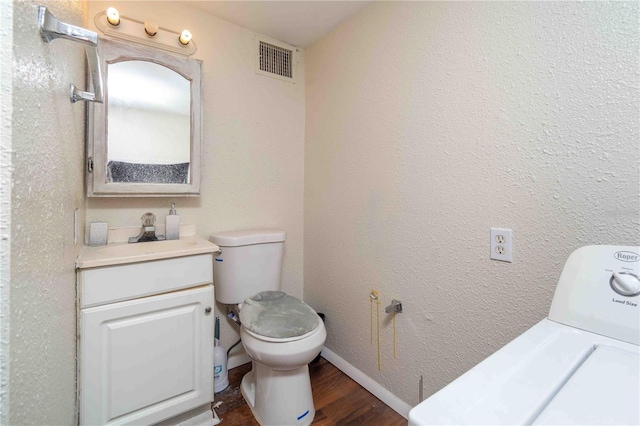 1144AND1142 7th St NW, Largo, FL 33770 - bathroom with washer / clothes dryer, vanity, and wood finished floors