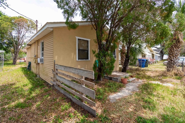 1144AND1142 7th St NW, Largo, FL 33770 - view of side of property featuring stucco siding and cooling unit