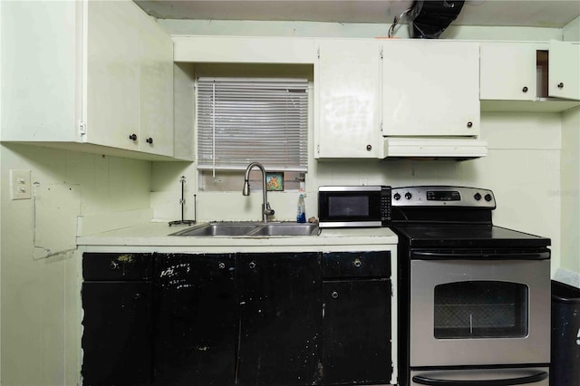 1144AND1142 7th St NW, Largo, FL 33770 - kitchen featuring appliances with stainless steel finishes, custom exhaust hood, light countertops, and white cabinets