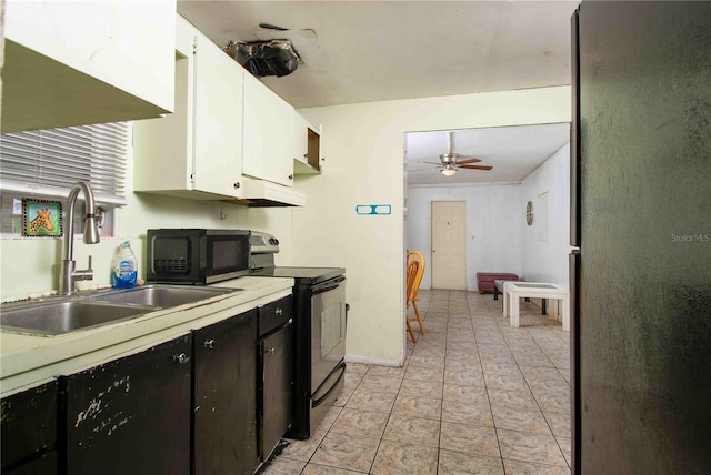 1144AND1142 7th St NW, Largo, FL 33770 - kitchen with electric range, white cabinetry, a ceiling fan, light countertops, and dark cabinets