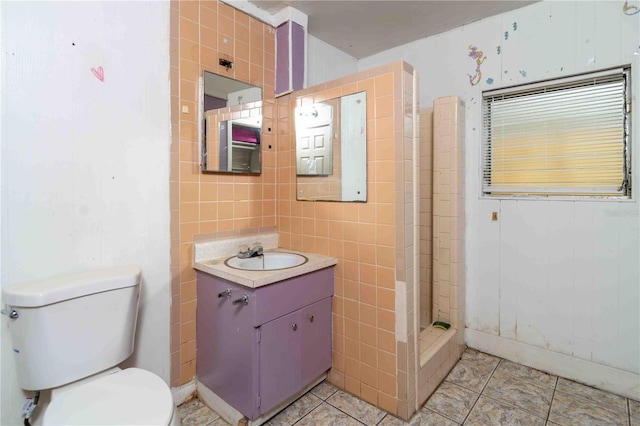 1144AND1142 7th St NW, Largo, FL 33770 - bathroom featuring vanity, tile walls, a stall shower, and tile patterned flooring