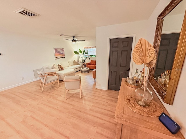 1972 Briarwood St, Dunedin, FL 34698 - living room with light wood-style floors and ceiling fan