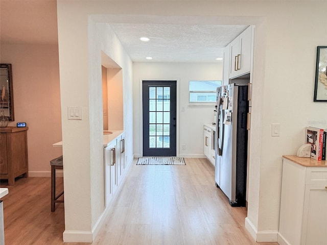1972 Briarwood St, Dunedin, FL 34698 - doorway to outside featuring light wood-style floors and recessed lighting