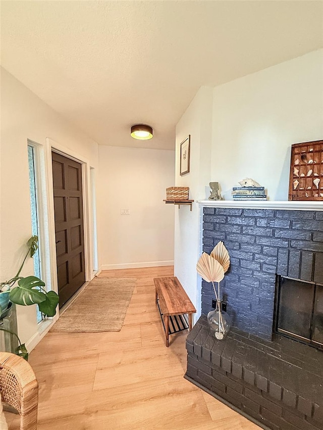 1972 Briarwood St, Dunedin, FL 34698 - entryway with a brick fireplace and wood finished floors