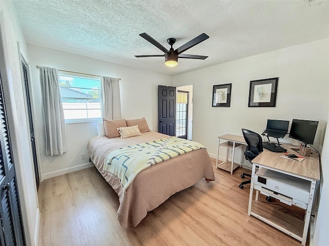 1972 Briarwood St, Dunedin, FL 34698 - bedroom with light wood finished floors, an office area, a textured ceiling, and ceiling fan
