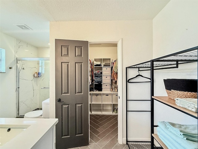 1972 Briarwood St, Dunedin, FL 34698 - bedroom featuring a closet, a walk in closet, and a textured ceiling