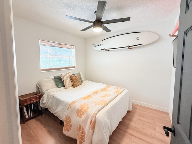 1972 Briarwood St, Dunedin, FL 34698 - bedroom featuring light wood finished floors, a textured ceiling, and ceiling fan