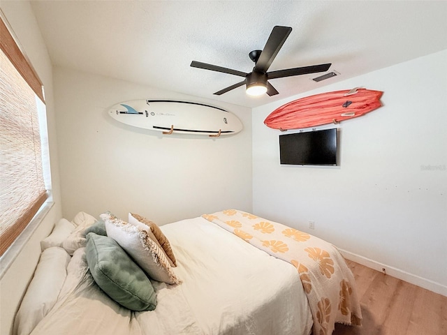 1972 Briarwood St, Dunedin, FL 34698 - bedroom with wood finished floors and a ceiling fan