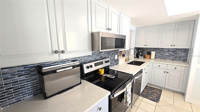 13 Windrush Bay Dr, Tarpon Springs, FL 34689 - kitchen with appliances with stainless steel finishes, backsplash, and white cabinets