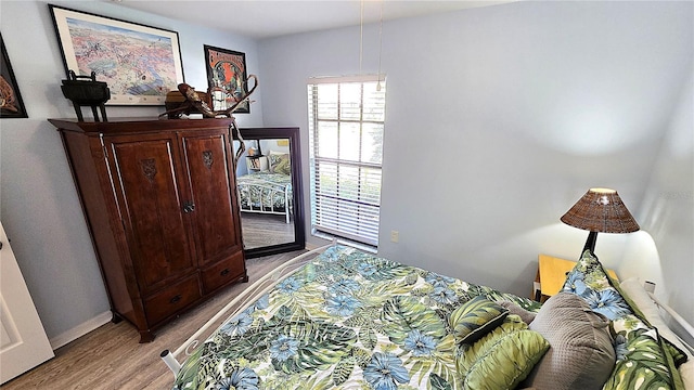 13 Windrush Bay Dr, Tarpon Springs, FL 34689 - bedroom with light wood-style flooring and access to exterior
