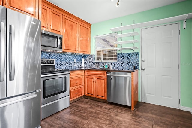 487 49th Ave N, Saint Petersburg, FL 33703 - kitchen with appliances with stainless steel finishes, brown cabinets, dark countertops, and backsplash