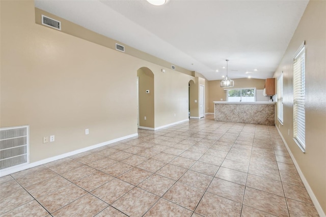 8020 Carriage Pointe Dr, Gibsonton, FL 33534 - unfurnished living room featuring arched walkways, light tile patterned floors, and lofted ceiling