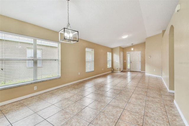 8020 Carriage Pointe Dr, Gibsonton, FL 33534 - spare room with light tile patterned flooring, vaulted ceiling, a chandelier, and arched walkways