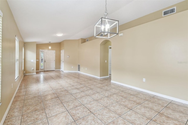 8020 Carriage Pointe Dr, Gibsonton, FL 33534 - unfurnished room with arched walkways, light tile patterned floors, and a chandelier