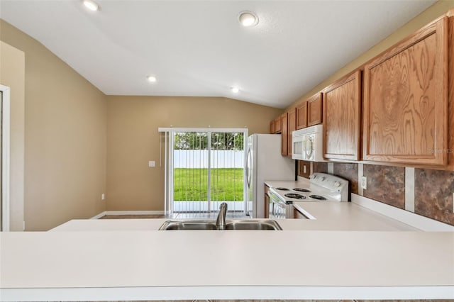 8020 Carriage Pointe Dr, Gibsonton, FL 33534 - kitchen featuring white appliances, vaulted ceiling, light countertops, recessed lighting, and decorative backsplash