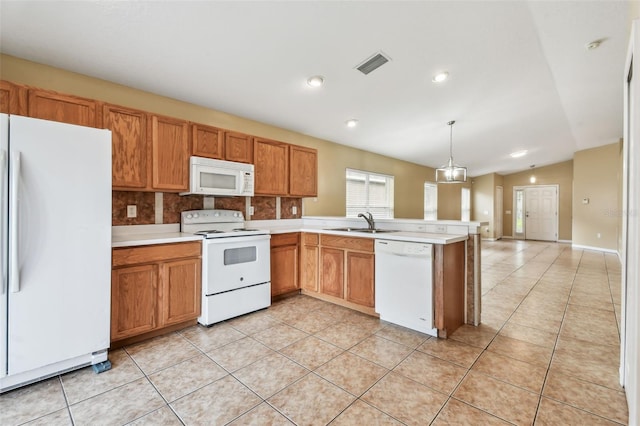 8020 Carriage Pointe Dr, Gibsonton, FL 33534 - kitchen with white appliances, light tile patterned floors, light countertops, a peninsula, and brown cabinetry