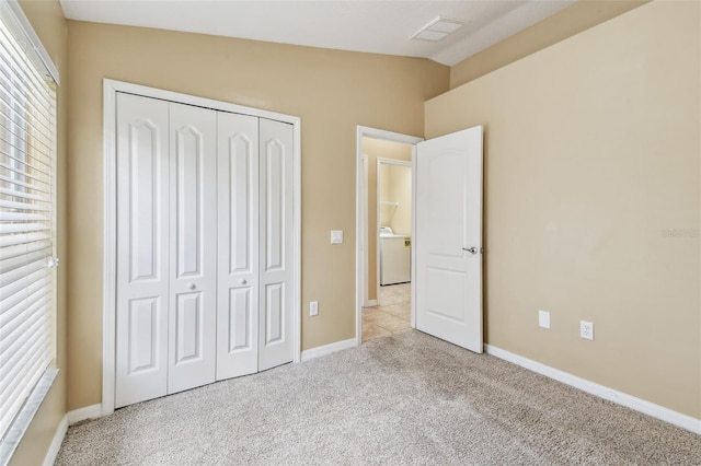 8020 Carriage Pointe Dr, Gibsonton, FL 33534 - unfurnished bedroom featuring washer / clothes dryer, a closet, carpet flooring, and vaulted ceiling