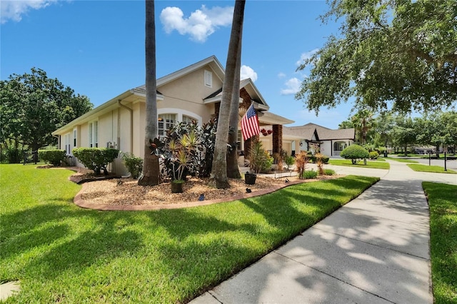 8704 Winsome Way, Land O Lakes, FL 34637 - view of side of home with stucco siding, a lawn, concrete driveway, and an attached garage