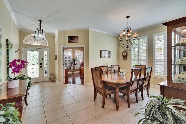 8704 Winsome Way, Land O Lakes, FL 34637 - dining room with light tile patterned flooring, ornamental molding, a chandelier, and french doors