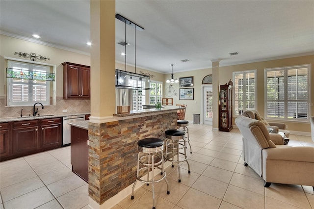 8704 Winsome Way, Land O Lakes, FL 34637 - kitchen featuring stainless steel dishwasher, healthy amount of natural light, open floor plan, decorative backsplash, and crown molding