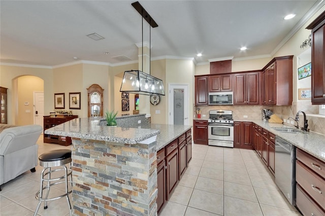 8704 Winsome Way, Land O Lakes, FL 34637 - kitchen with stainless steel appliances, light tile patterned flooring, arched walkways, open floor plan, and tasteful backsplash