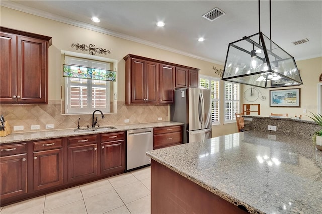 8704 Winsome Way, Land O Lakes, FL 34637 - kitchen featuring stainless steel appliances, ornamental molding, decorative backsplash, light stone countertops, and hanging light fixtures