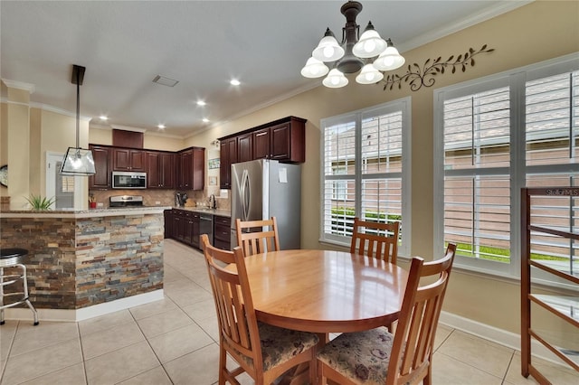 8704 Winsome Way, Land O Lakes, FL 34637 - dining space with light tile patterned flooring, a chandelier, and ornamental molding