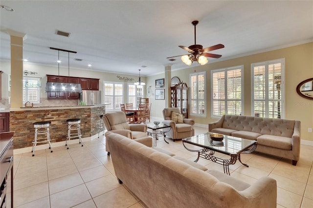 8704 Winsome Way, Land O Lakes, FL 34637 - living area featuring decorative columns, ornamental molding, light tile patterned floors, and a ceiling fan
