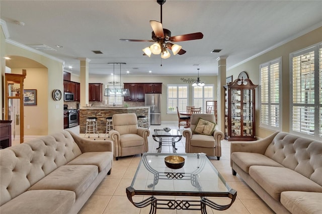 8704 Winsome Way, Land O Lakes, FL 34637 - living area with ornate columns, ceiling fan, light tile patterned floors, ornamental molding, and a chandelier