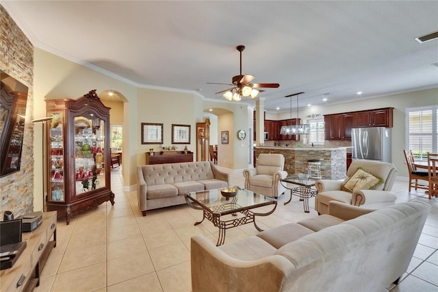 8704 Winsome Way, Land O Lakes, FL 34637 - living room with arched walkways, light tile patterned flooring, a ceiling fan, crown molding, and recessed lighting