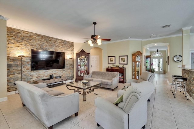 8704 Winsome Way, Land O Lakes, FL 34637 - living room with arched walkways, light tile patterned flooring, ceiling fan, and ornamental molding