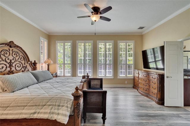 8704 Winsome Way, Land O Lakes, FL 34637 - bedroom with multiple windows, crown molding, light wood-style floors, and ceiling fan