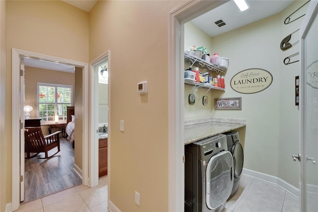 8704 Winsome Way, Land O Lakes, FL 34637 - washroom with washer and clothes dryer and light tile patterned floors