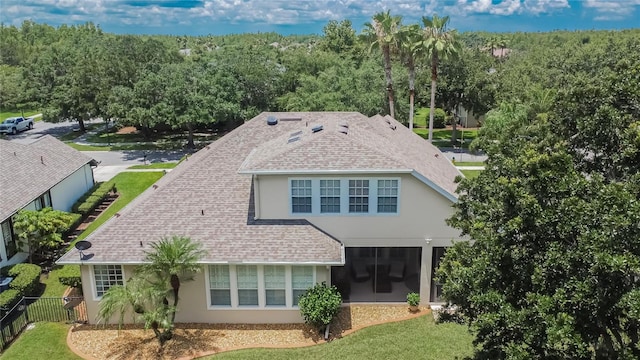 8704 Winsome Way, Land O Lakes, FL 34637 - back of house with stucco siding and roof with shingles