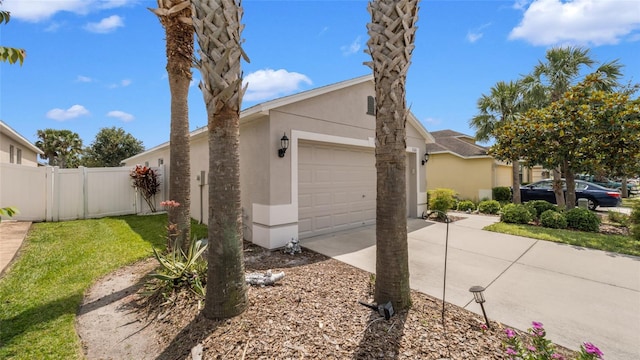7120 Forest Mere Dr, Riverview, FL 33578 - view of side of property with an attached garage, stucco siding, and concrete driveway