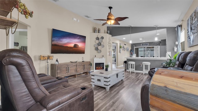 7120 Forest Mere Dr, Riverview, FL 33578 - living area with a ceiling fan, wood finished floors, and a glass covered fireplace
