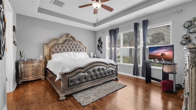 7120 Forest Mere Dr, Riverview, FL 33578 - bedroom featuring wood finished floors, a raised ceiling, and a ceiling fan