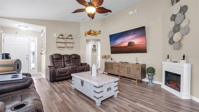 7120 Forest Mere Dr, Riverview, FL 33578 - living room featuring ceiling fan, wood finished floors, and a glass covered fireplace