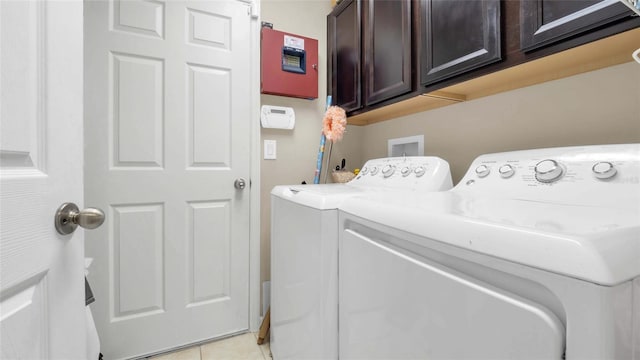 7120 Forest Mere Dr, Riverview, FL 33578 - washroom featuring washing machine and clothes dryer, cabinet space, and light tile patterned flooring