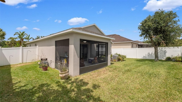 7120 Forest Mere Dr, Riverview, FL 33578 - back of property with a sunroom, stucco siding, a fenced backyard, and a ceiling fan